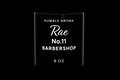 Black candle with 'Humble Aroma Rae No.11 Barbershop' text on a white background